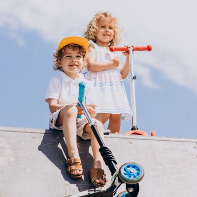 Versicherung kinderleicht? : Zwei Kinder sind mit ihren Scootern in der Halfpipe