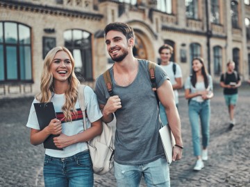 Junge Frau und junger Mann laufen lachend nebeneinander