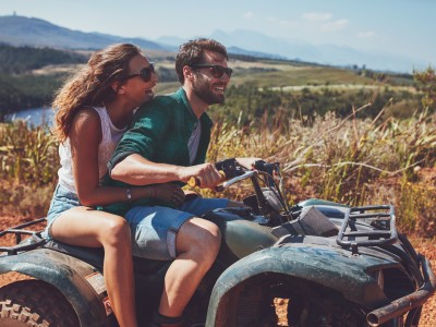 Paar mit dem Quad im Gelände unterwegs